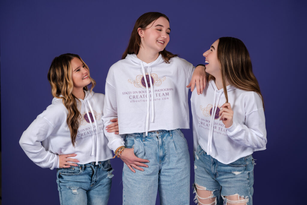 Group of 3 high school seniors in Stacey Lyn Boutique Photography branded cropped hoodies